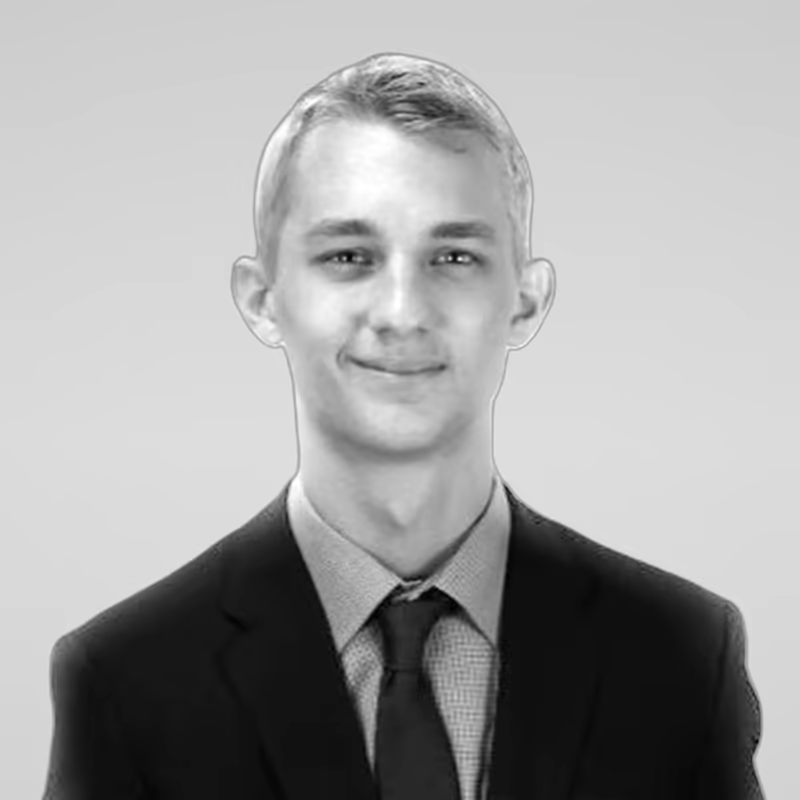 Black and white portrait of Austin Anderson on a light gray studio background.