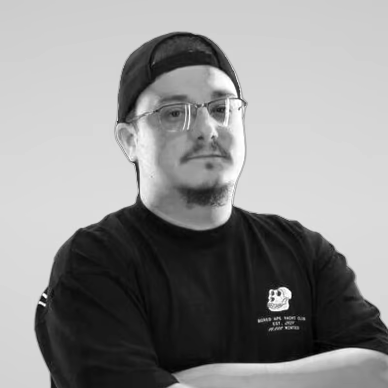 Black and white portrait of Brett Buerhaus on a light gray studio background.