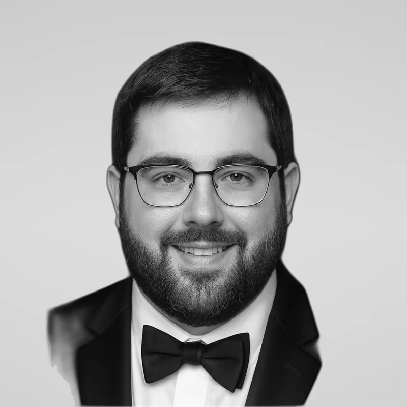 Black and white portrait of Craig Goldstein on a light gray studio background.
