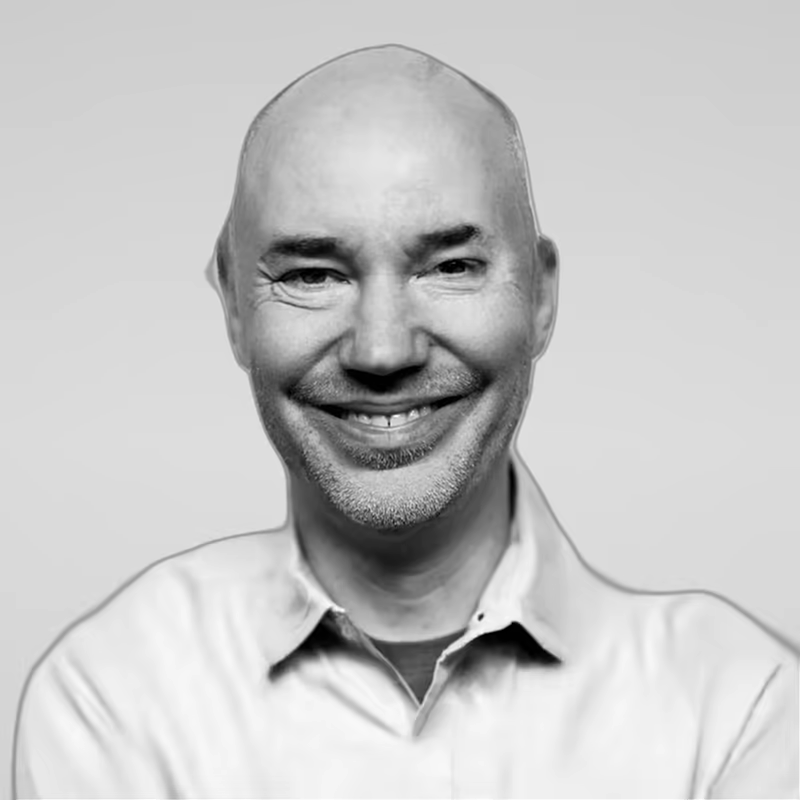 Black and white portrait of Eric Seppanen on a light gray studio background.