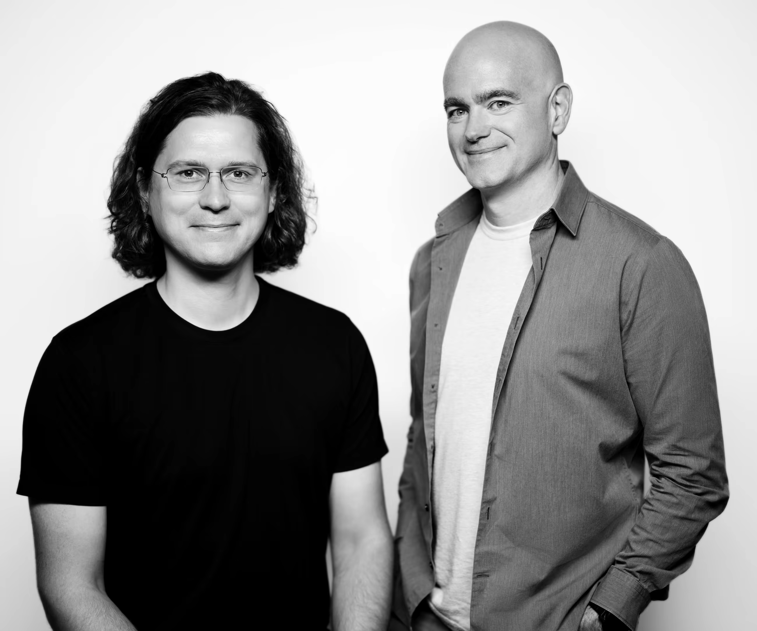 Black and white portrait of YSecurity co-founders Sasha Sinkevich and Jon McLachlan against a white studio background.