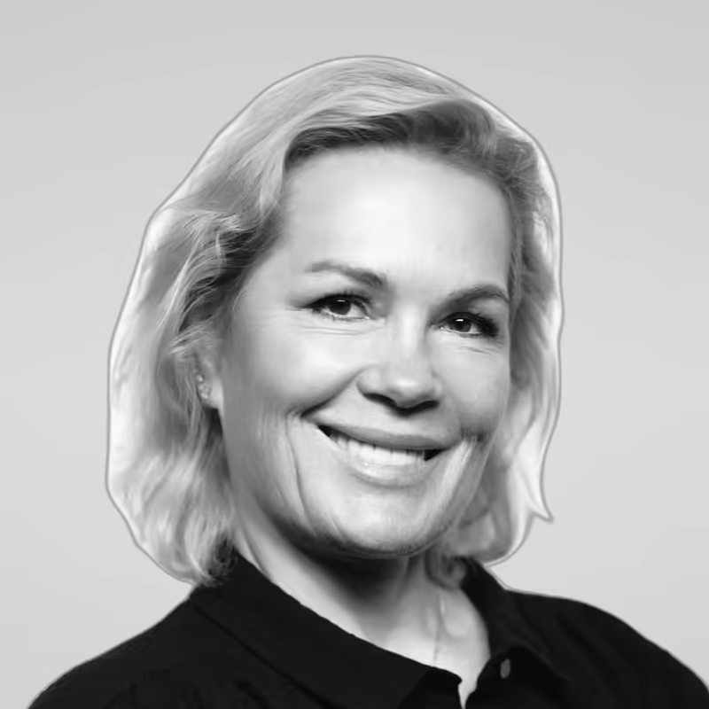 Black and white portrait of Iryna Sinkevich on a light gray studio background.