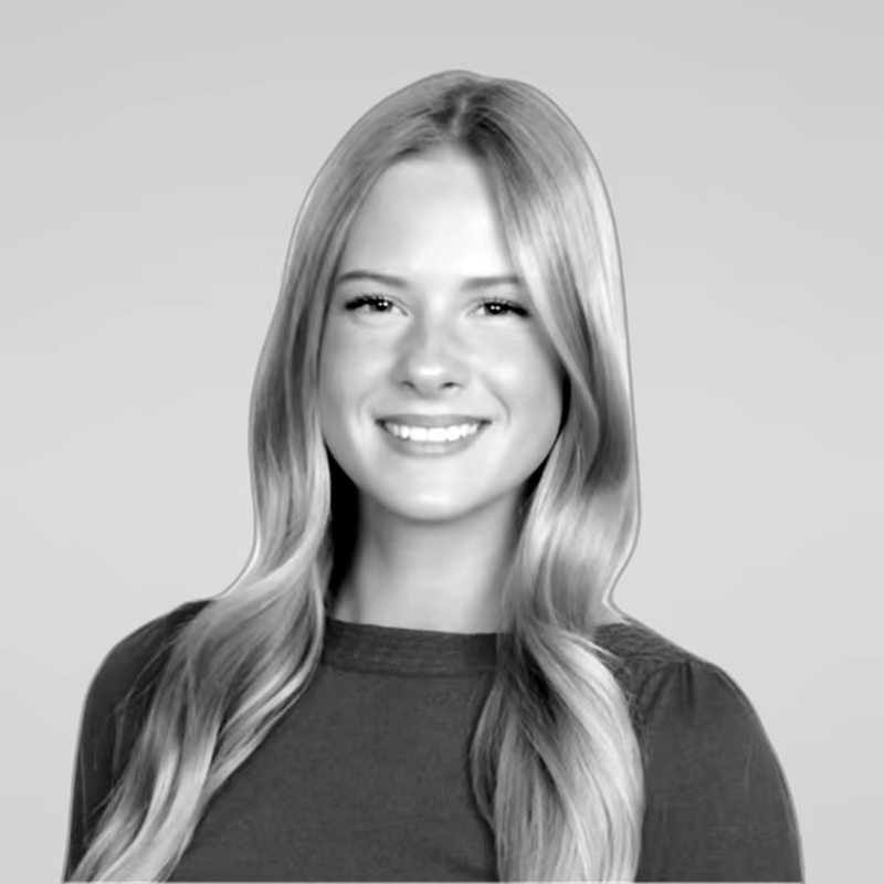 Black and white portrait of Kailyn Lund on a light gray studio background.
