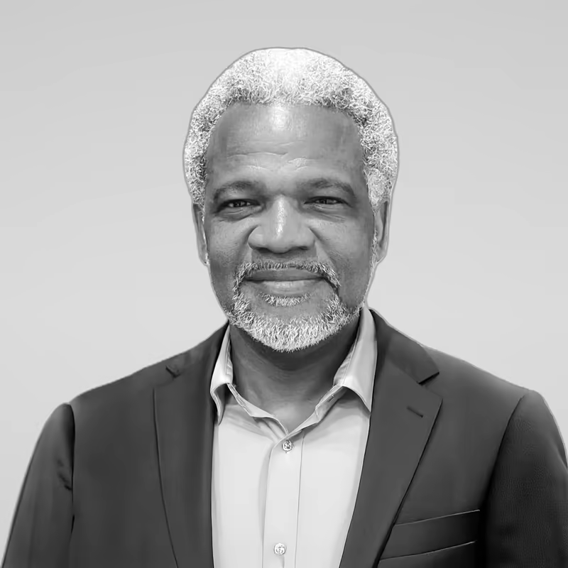 Black and white portrait of Keith Parkman on a light gray studio background.