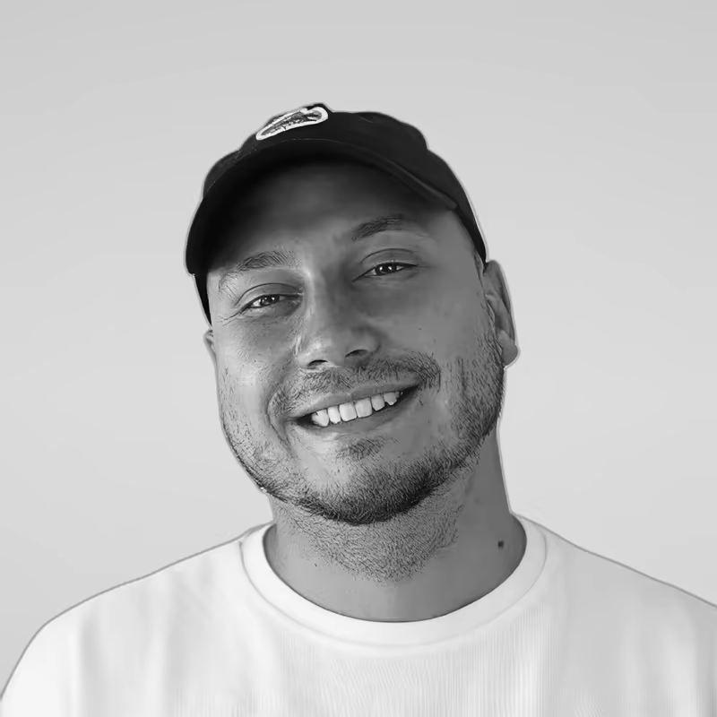 Black and white portrait of Kyrylo Yevdokymov on a light gray studio background.