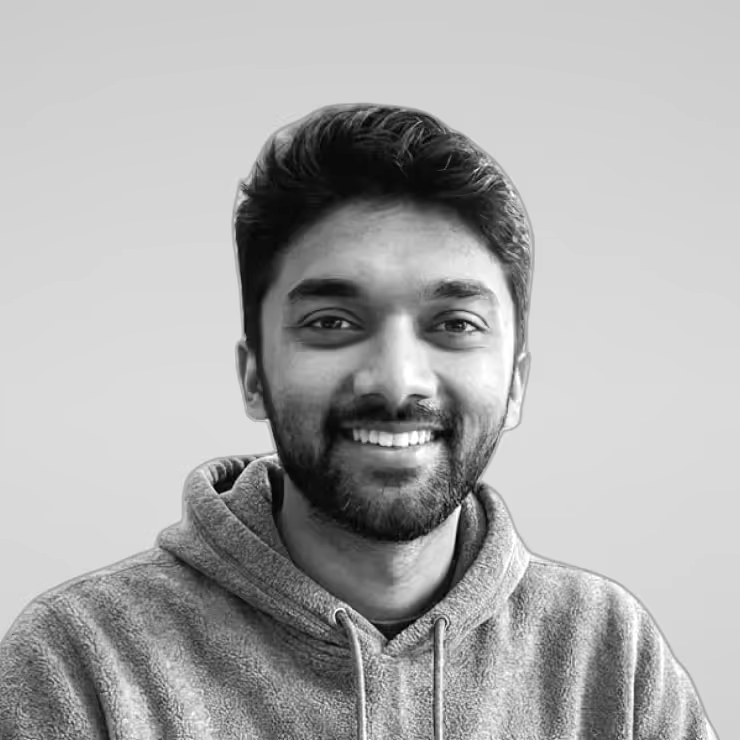 Black and white portrait of Manarth Bhavsar on a light gray studio background.