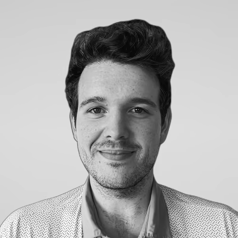 Black and white portrait of Matthew Harrison on a light gray studio background.