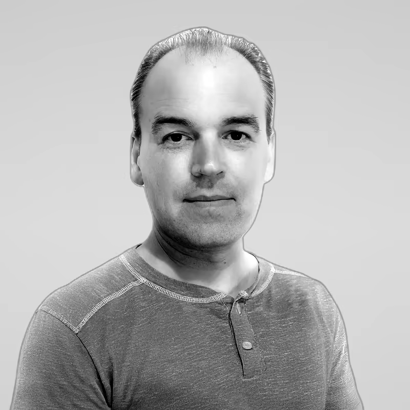 Black and white portrait of Miroslav Gavrilov on a light gray studio background.