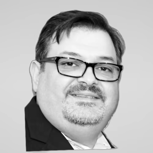 Black and white portrait of Phillip Valaveris on a light gray studio background.