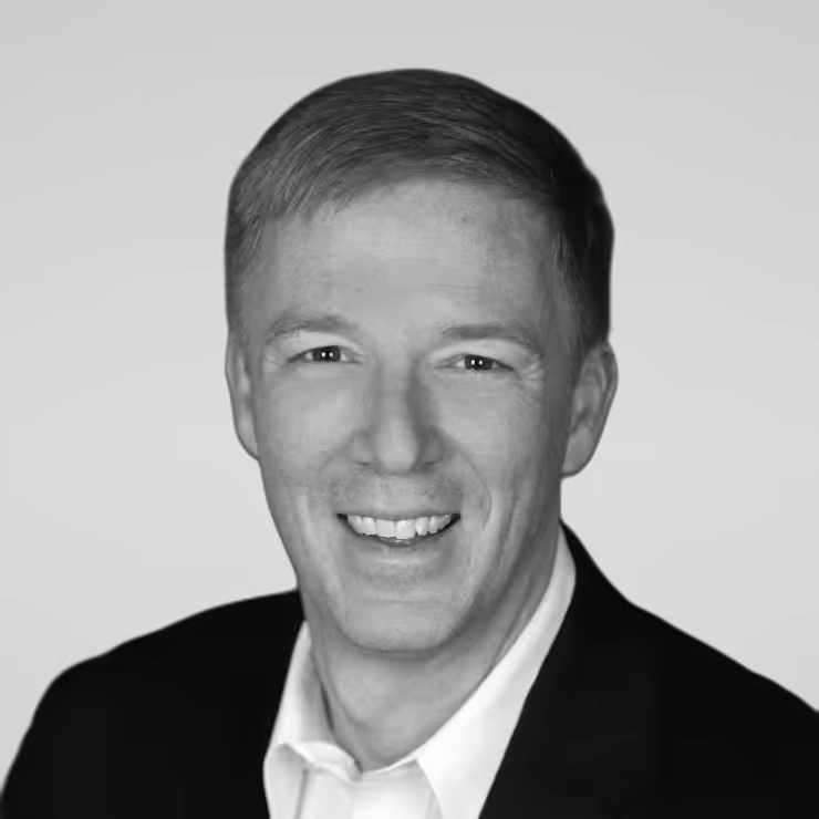 Black and white portrait of Steve White on a light gray studio background.