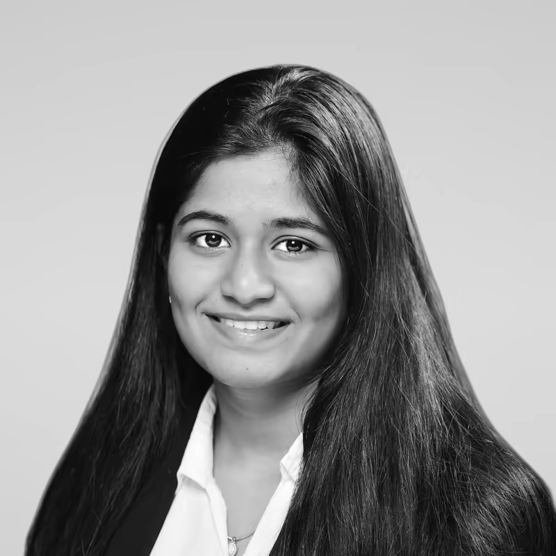 Black and white portrait of Swetha Botta on a light gray studio background.
