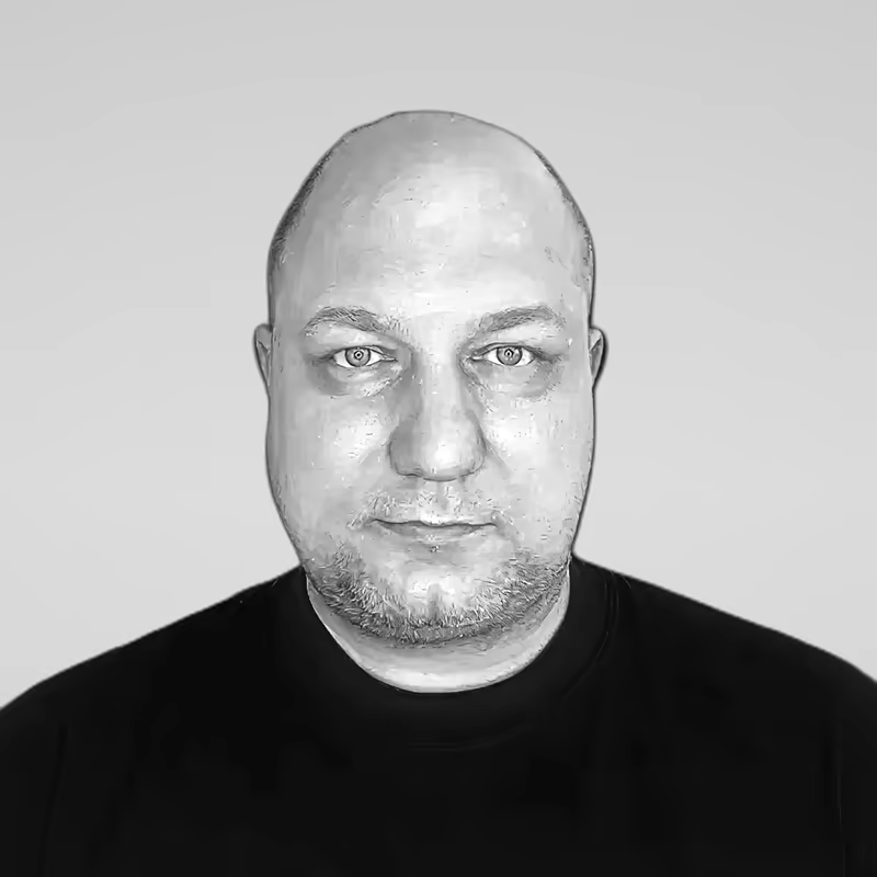 Black and white portrait of Victor Fateyev on a light gray studio background.
